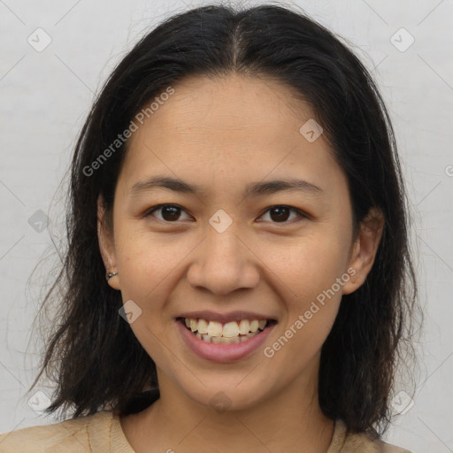 Joyful latino young-adult female with medium  brown hair and brown eyes