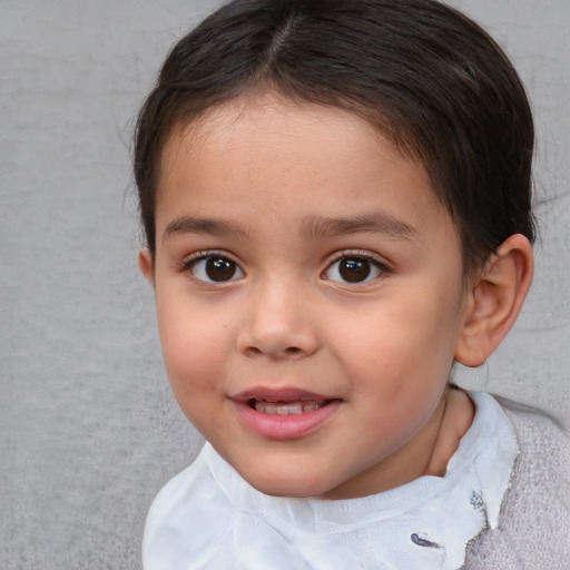 Joyful white child female with short  brown hair and brown eyes