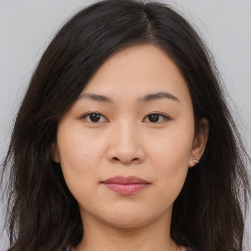 Joyful asian young-adult female with long  brown hair and brown eyes