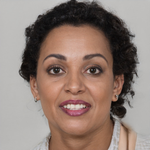 Joyful black adult female with short  brown hair and brown eyes