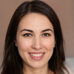 Joyful white young-adult female with long  brown hair and brown eyes