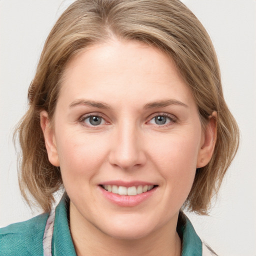 Joyful white young-adult female with medium  brown hair and blue eyes