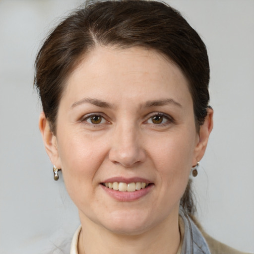 Joyful white adult female with short  brown hair and grey eyes