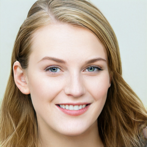 Joyful white young-adult female with long  brown hair and blue eyes