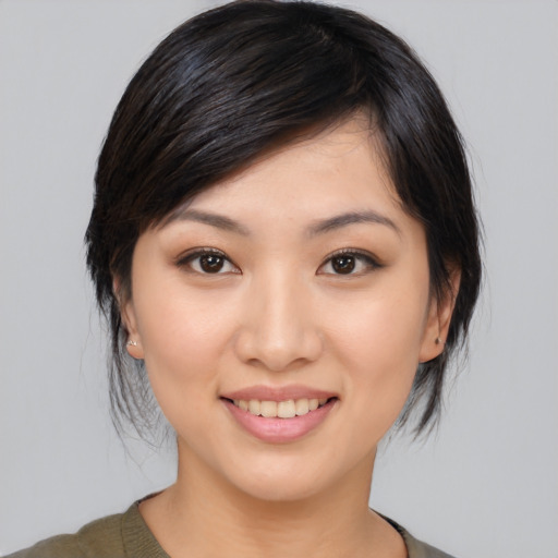 Joyful asian young-adult female with medium  brown hair and brown eyes