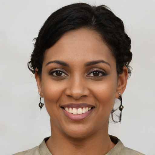 Joyful latino young-adult female with short  black hair and brown eyes