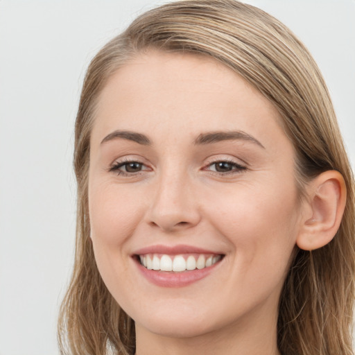 Joyful white young-adult female with long  brown hair and grey eyes