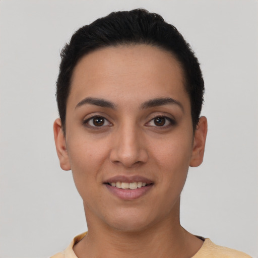 Joyful latino young-adult female with short  black hair and brown eyes