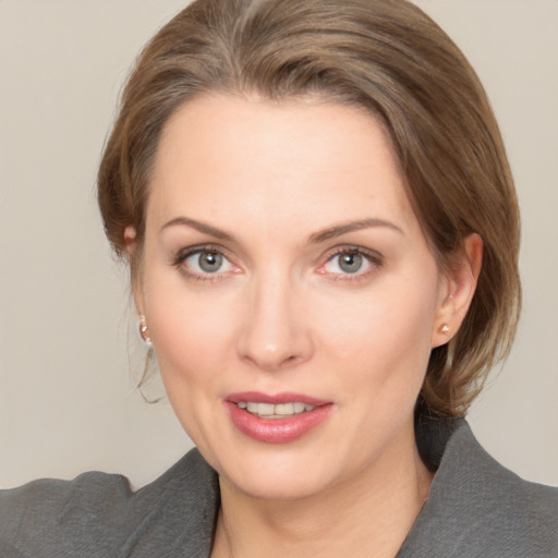 Joyful white adult female with medium  brown hair and brown eyes