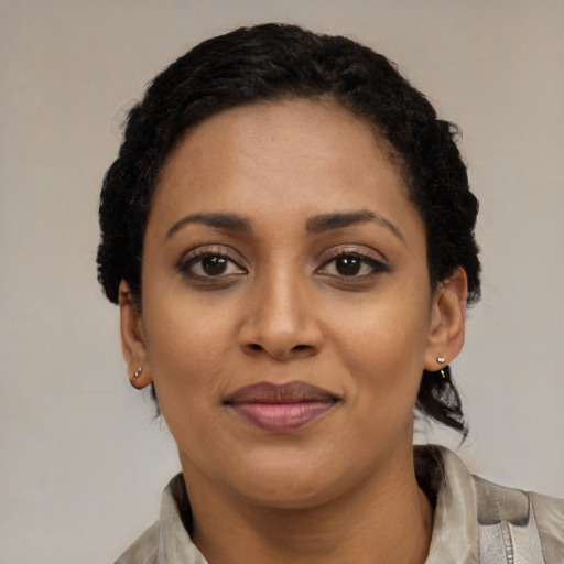 Joyful latino young-adult female with short  black hair and brown eyes