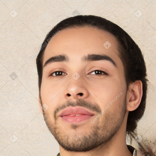 Joyful white young-adult male with short  black hair and brown eyes