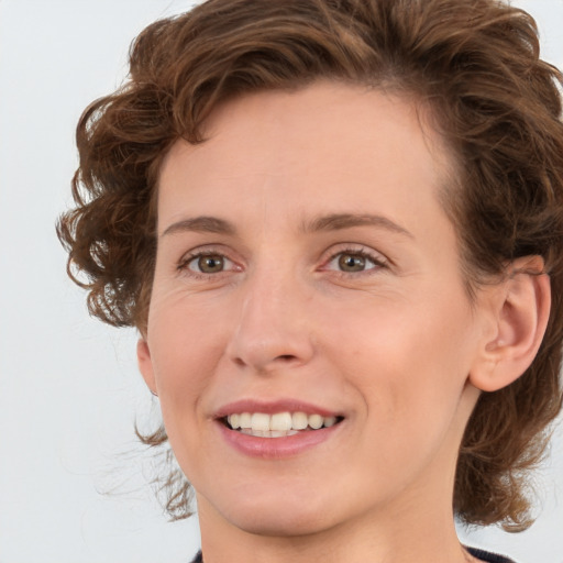 Joyful white young-adult female with medium  brown hair and green eyes