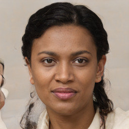 Joyful black young-adult female with medium  brown hair and brown eyes