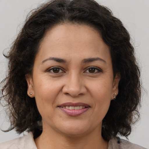 Joyful white adult female with medium  brown hair and brown eyes