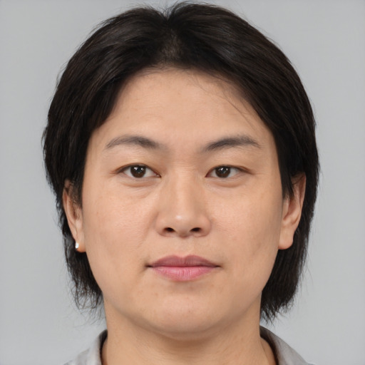 Neutral asian adult female with medium  brown hair and brown eyes