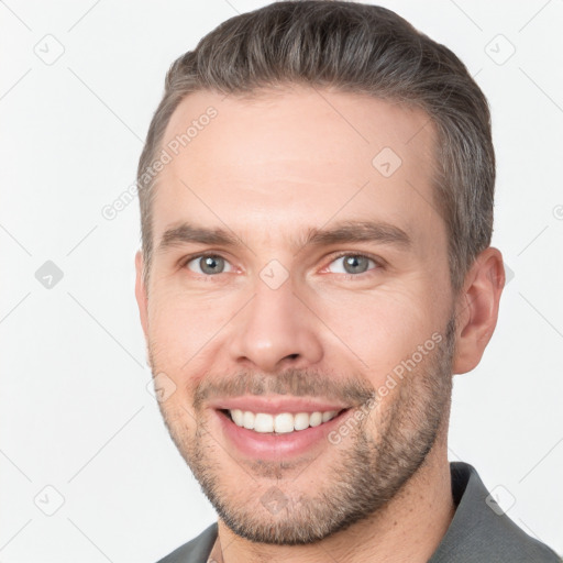 Joyful white young-adult male with short  brown hair and brown eyes