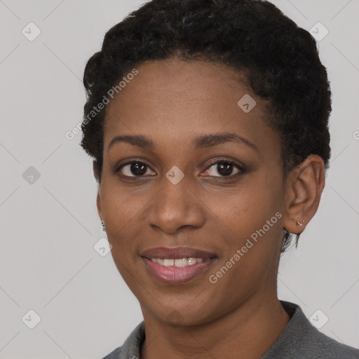 Joyful black young-adult female with short  black hair and brown eyes