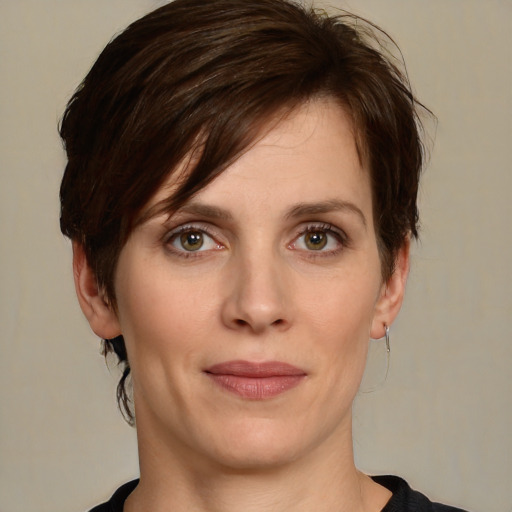 Joyful white young-adult female with medium  brown hair and green eyes