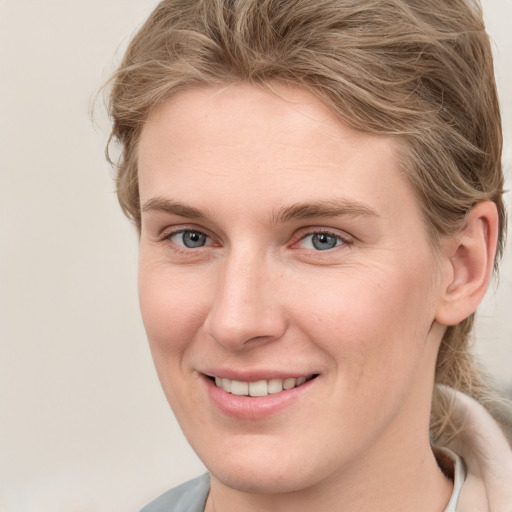 Joyful white young-adult female with short  brown hair and grey eyes