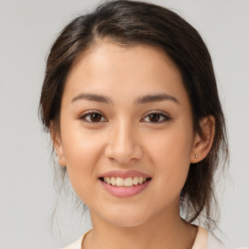 Joyful white young-adult female with medium  brown hair and brown eyes