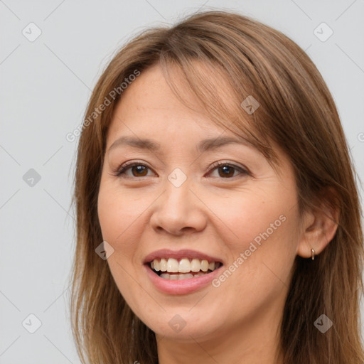 Joyful white adult female with long  brown hair and brown eyes