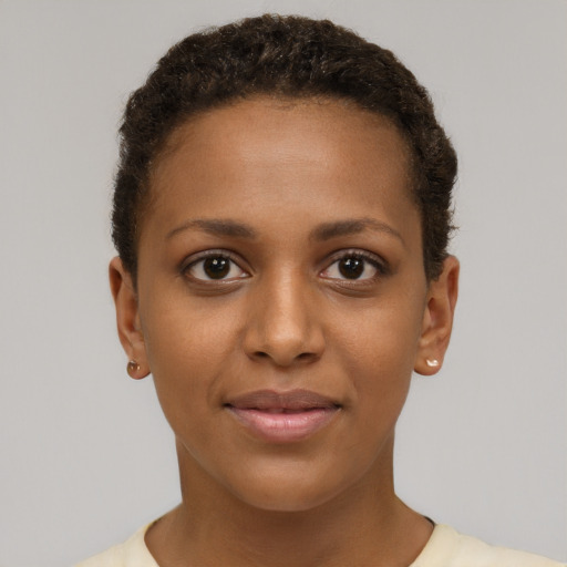 Joyful black young-adult female with short  brown hair and brown eyes