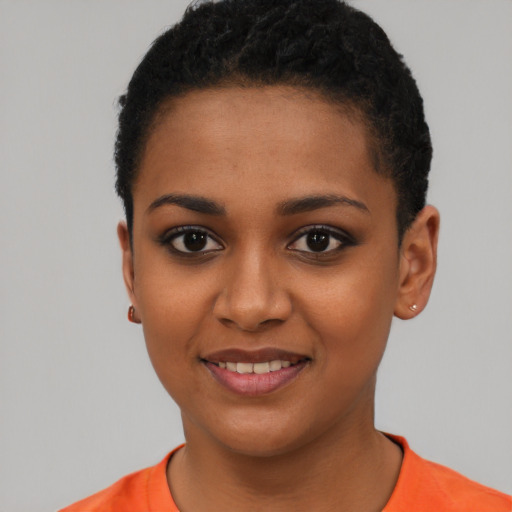 Joyful black young-adult female with short  black hair and brown eyes