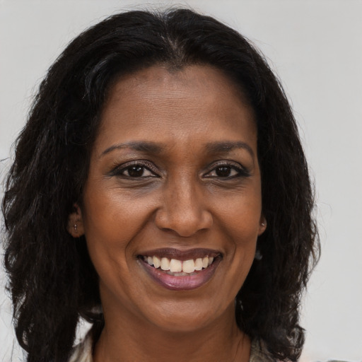 Joyful latino adult female with long  brown hair and brown eyes