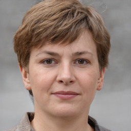 Joyful white young-adult female with short  brown hair and grey eyes