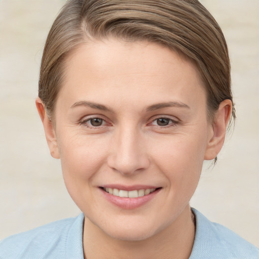 Joyful white young-adult female with short  brown hair and grey eyes