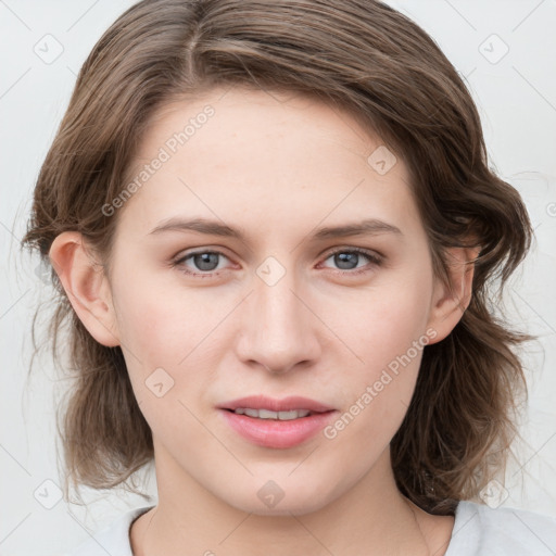 Joyful white young-adult female with medium  brown hair and blue eyes