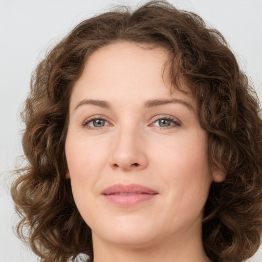 Joyful white young-adult female with medium  brown hair and green eyes