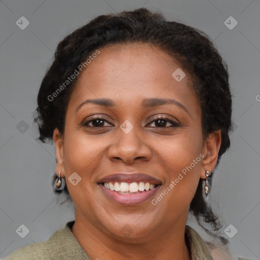 Joyful black adult female with medium  brown hair and brown eyes