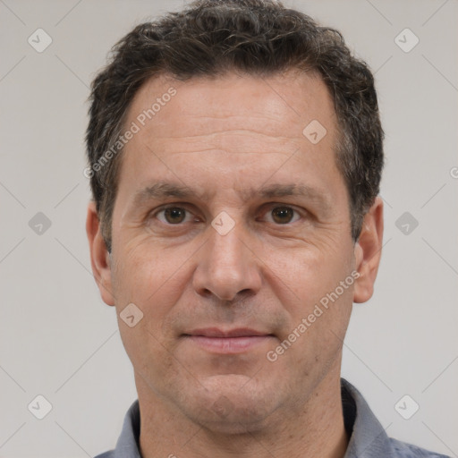 Joyful white adult male with short  brown hair and brown eyes