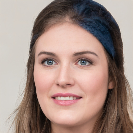 Joyful white young-adult female with long  brown hair and grey eyes