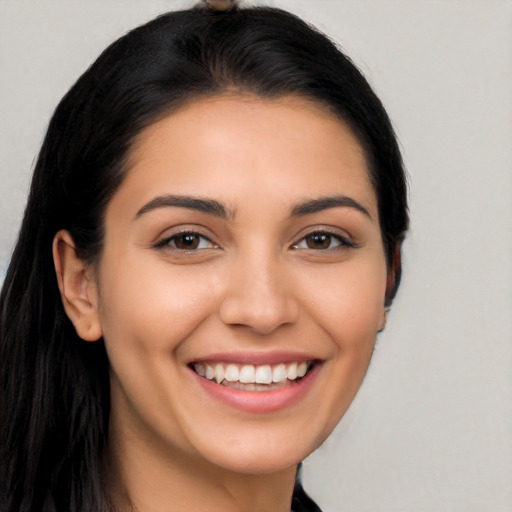 Joyful latino young-adult female with long  brown hair and brown eyes