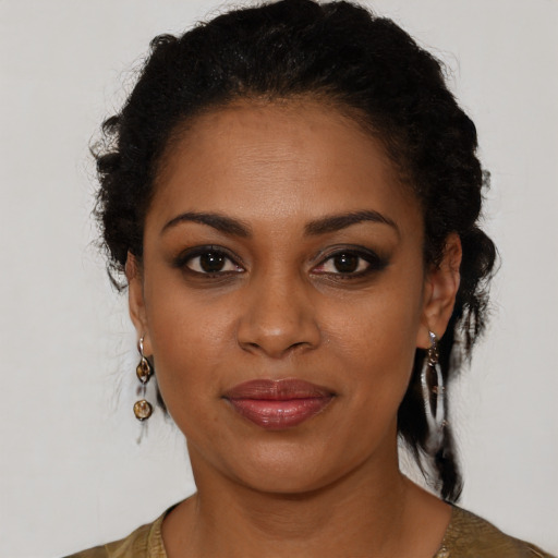 Joyful black young-adult female with long  black hair and brown eyes