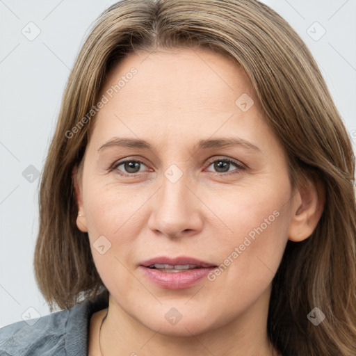 Joyful white adult female with medium  brown hair and grey eyes