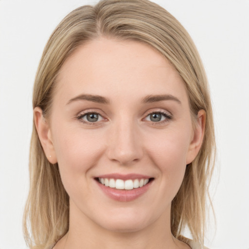 Joyful white young-adult female with long  brown hair and blue eyes