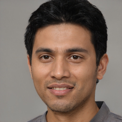 Joyful asian young-adult male with short  black hair and brown eyes