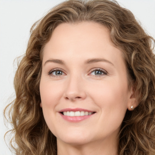 Joyful white young-adult female with long  brown hair and green eyes