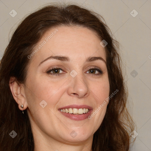 Joyful white adult female with long  brown hair and brown eyes