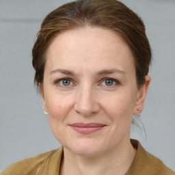 Joyful white adult female with short  brown hair and grey eyes