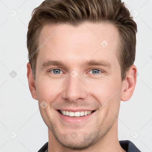 Joyful white young-adult male with short  brown hair and grey eyes