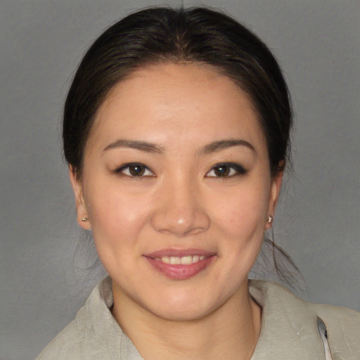 Joyful white young-adult female with medium  brown hair and brown eyes