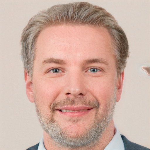 Joyful white adult male with short  brown hair and grey eyes