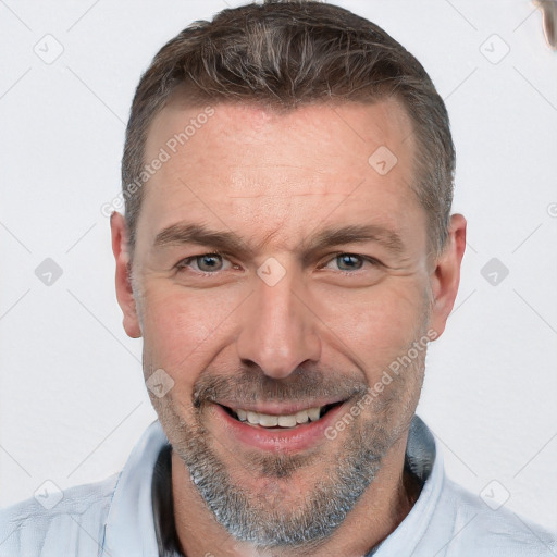 Joyful white adult male with short  brown hair and grey eyes