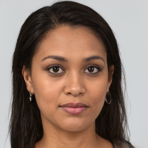 Joyful latino young-adult female with long  brown hair and brown eyes
