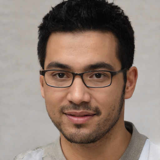 Joyful white young-adult male with short  black hair and brown eyes