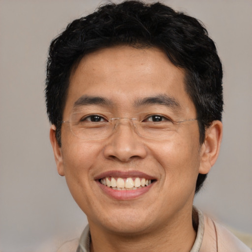 Joyful asian adult male with short  brown hair and brown eyes